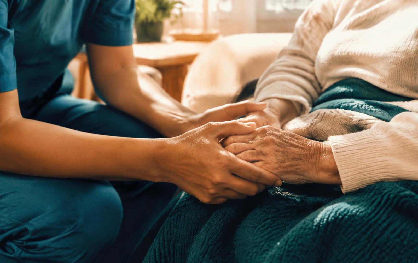 Caregiver holding a patient's hands